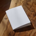 A blank white notebook resting on a beautifully textured wooden table, perfect for creative thoughts and ideas. Royalty Free Stock Photo
