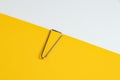 Blank white Notepaper with paperclip on yellow background