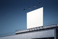 Blank white outdoor billboard with backlights on industrial building rooftop at night sky background. 3D rendering, mock up Royalty Free Stock Photo