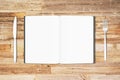 Blank white pages of opened diary with fork and knife on wooden Royalty Free Stock Photo