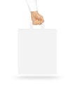 Blank white paper bag mock up holding in hand. Empty plastic pac