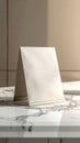 Blank White Paper Bag Mockup Displayed on Marble Counter Top in Studio Royalty Free Stock Photo