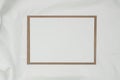 Blank white paper on brown paper envelope with white cloth. Mock-up of horizontal blank greeting card. Top view of Craft envelope