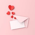 Blank white paper card on pink envelope and red origami hearts on pink pastel color background Royalty Free Stock Photo