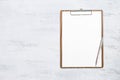 Blank white paper on clipboard and new pen on white texture background Royalty Free Stock Photo