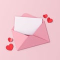 Blank white paper in pink envelope and red origami hearts on pink pastel color background Royalty Free Stock Photo