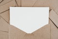 Blank white paper is placed on the open brown paper envelope. Mock-up of horizontal blank greeting card. Top view of Craft paper Royalty Free Stock Photo