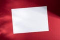 Blank white paper on red background with soft shadows, perfect for mockup, template, or design presentation