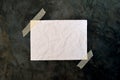 Blank white paper on rough black surface Royalty Free Stock Photo