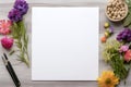 Blank white paper sheet, pen and colorful flowers on wooden background with copy space Royalty Free Stock Photo