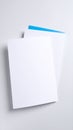 Blank white paper sheets with blue accent on a light gray background Royalty Free Stock Photo