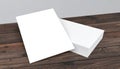 Blank white paper sheets stacked on a rustic wooden table surface Royalty Free Stock Photo