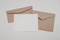 Blank white paper on the two brown paper envelope. Mock-up of horizontal blank greeting card. Top view of Craft paper envelope on Royalty Free Stock Photo