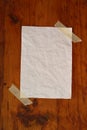 Blank white paper on wood grain surface