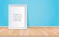 Blank white picture frame on the blue wall and wooden floor Royalty Free Stock Photo