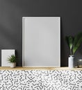 Blank white picture frame in modern stylish interior with dark gray wall and plants on the cupboard, 3d rendering Royalty Free Stock Photo