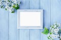 Blank White Picture Frame over Light Blue Spring Background Royalty Free Stock Photo