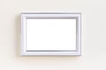 Blank white picture frame on a plain beige background.