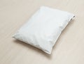 Blank white plastic bag package mockup template on wooden background. Royalty Free Stock Photo