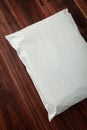 Blank white plastic bag packaging mockup on wooden background Royalty Free Stock Photo