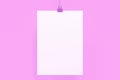 Blank white poster with binder clip mockup on violet background Royalty Free Stock Photo