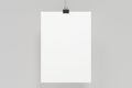 Blank white poster with binder clip mockup on white background Royalty Free Stock Photo