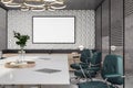 Blank white poster in black frame with space for your logo or text on figure grey wall background in conference room with green Royalty Free Stock Photo