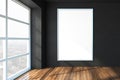 Blank white poster on black wall in modern office with wooden floor and big window, mock up Royalty Free Stock Photo