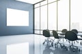 Blank white poster on black wall in spacious modern meeting room with black furniture and big window with city view. Mockup Royalty Free Stock Photo