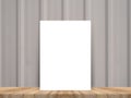 Blank white poster leaning at tropical wood table top with plank Royalty Free Stock Photo