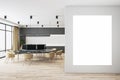 Blank white poster on light wall in coworking space with modern furniture, wooden floor and big window. Mockup Royalty Free Stock Photo