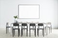 Blank white poster on light wall in spacious dining room with monochrome chairs, wooden table and floor. Mockup Royalty Free Stock Photo