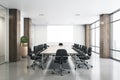 Blank white poster in modern conference room with big wooden table and columns, black chairs, glossy floor and big window. Mockup Royalty Free Stock Photo