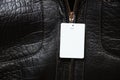 blank white price tag hanging on a black men's leather sheepskin coat close up, price tag on clothes Royalty Free Stock Photo