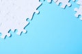 Blank white puzzle pieces on blue background, flat lay. Space for text Royalty Free Stock Photo