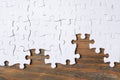 Blank white puzzle pieces on wooden background Royalty Free Stock Photo