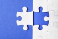 Blank white puzzle with separated piece on blue background Royalty Free Stock Photo