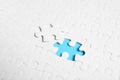 Blank white puzzle with separated piece on blue background Royalty Free Stock Photo