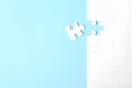 Blank white puzzle with separated piece on blue background, flat lay. Space for text Royalty Free Stock Photo