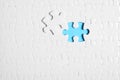 Blank white puzzle with separated piece on blue background, top view Royalty Free Stock Photo