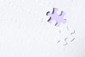 Blank white puzzle with separated piece on violet background. Space for text Royalty Free Stock Photo