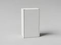 A blank white rectangular box standing upright on a plain gray background and casting a subtle shadow Royalty Free Stock Photo