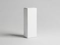 A blank white rectangular box standing upright on a plain grey background with subtle shadow Royalty Free Stock Photo