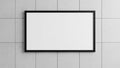 Blank white rectangular canvas within a thin black frame mounted on a textured grey concrete tile wall background Royalty Free Stock Photo
