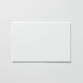 A blank white rectangular card lies centered on a smooth, slightly textured white Royalty Free Stock Photo