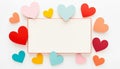 blank white rectangular card with red border framed by colorful paper hearts Royalty Free Stock Photo