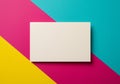 A blank, white rectangular card rests on a vibrant, diagonal tri-color background. The Royalty Free Stock Photo