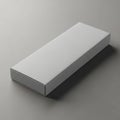 Blank white rectangular cardboard box resting on a textured gray surface Royalty Free Stock Photo