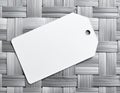 Blank white rectangular tag with rounded corner and string on woven textured background Royalty Free Stock Photo