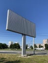 Blank white road billboard in city in summer sunny day. Street advertising poster, mock up, Glued paper mockup Royalty Free Stock Photo